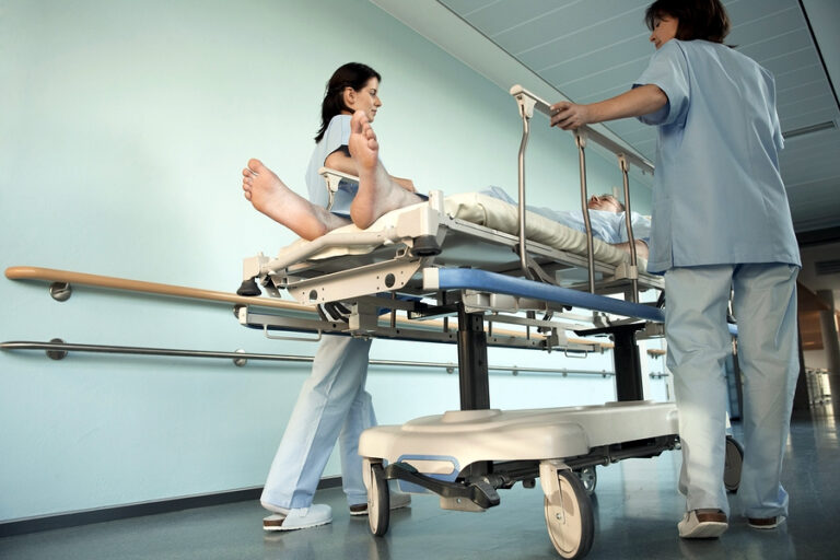 bigstock Nurses Moving Patient on gurne 7309120 768x512